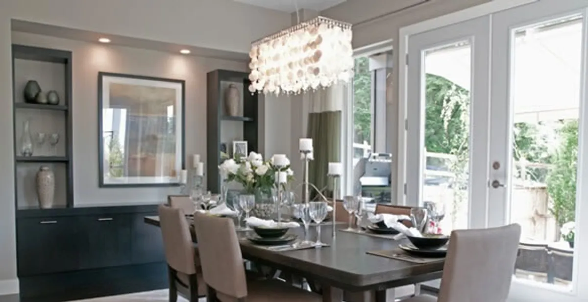 Elegant dining room chandelier installation above table in Savannah, GA