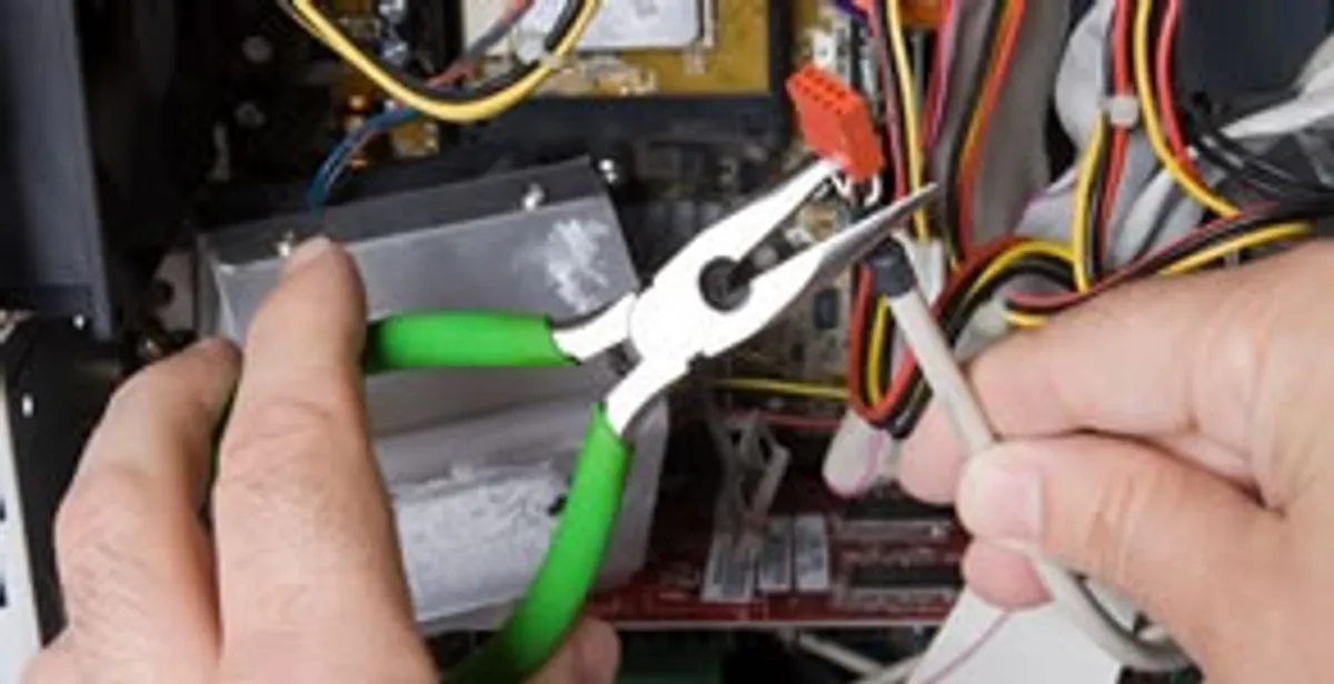Licensed electrical contractor performing electrical repair with tools in Tybee Island, GA