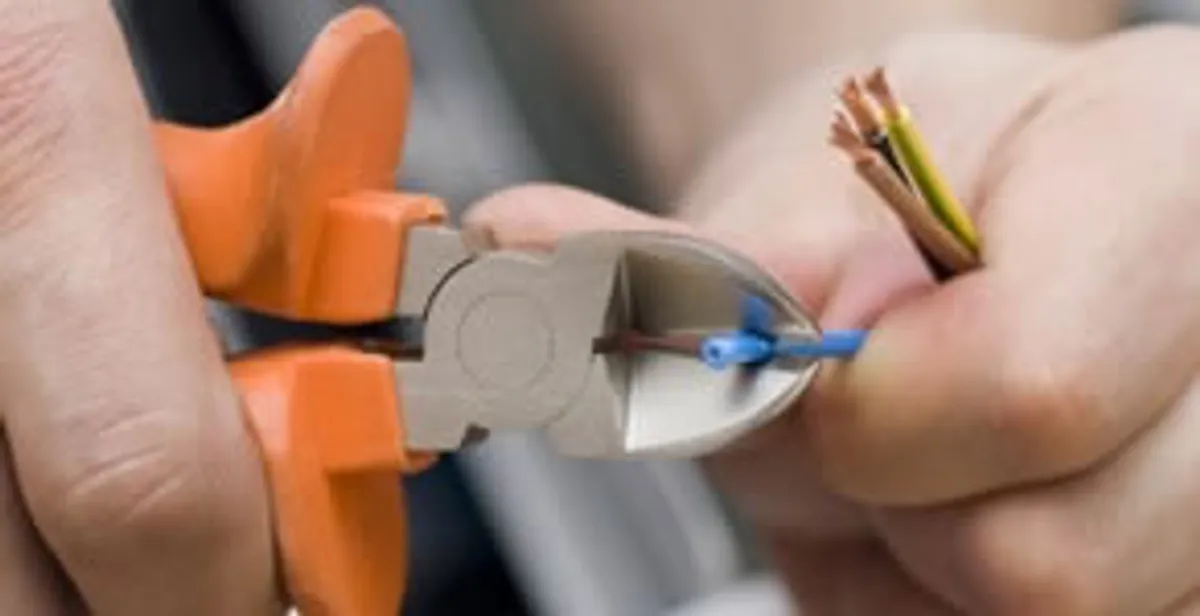 professional electrical services showing precise wire cutting by licensed electricians in Savannah, GA